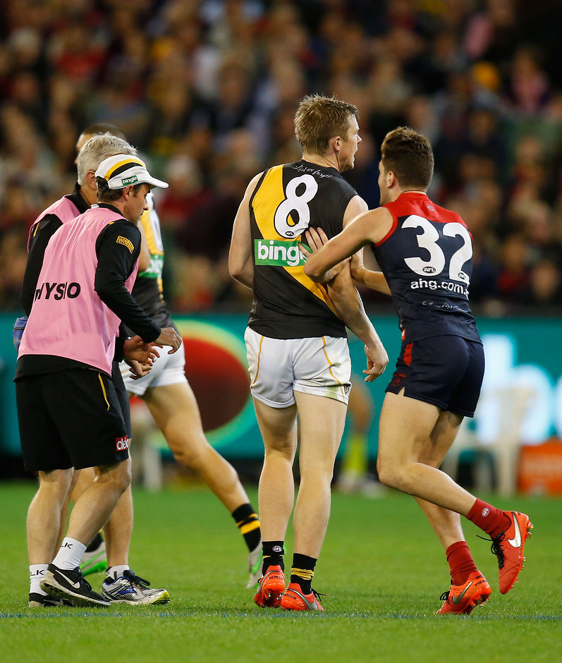AFL 2016 Rd 05 - Melbourne v Richmond MELBOURNE, AUSTRALIA - APRIL 24: Tomas Bugg of the Demons interferes with Jack Riewoldt of the Tigers as he leaves the field injured during the 2016 AFL Round 05 match between the Melbourne Demons and the Richmond Tigers at the Melbourne Cricket Ground, Melbourne on April 24, 2016. (Photo by Michael Willson/AFL Media)